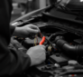 Technician working on vehicle electrical systems